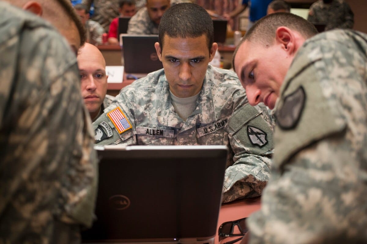 Military officers looking at a computer.