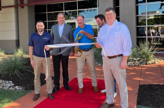 TST employees at a ribbon cutting ceremony
