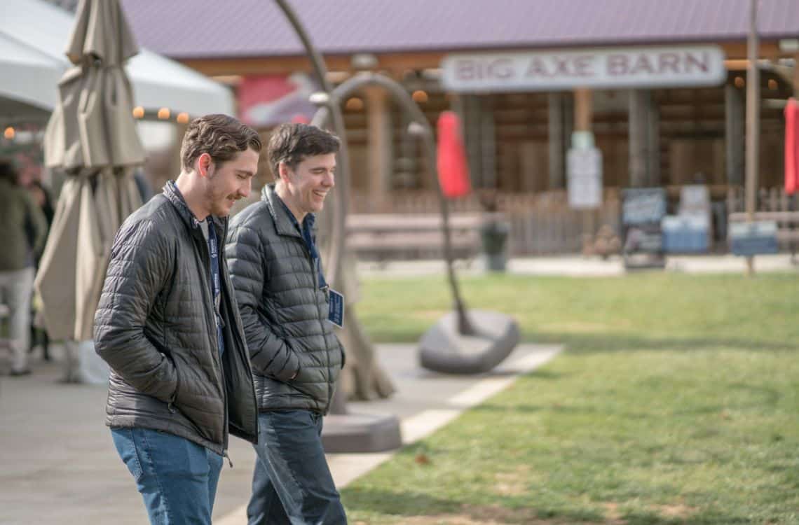 Two TST employees smiling and walking together at an event