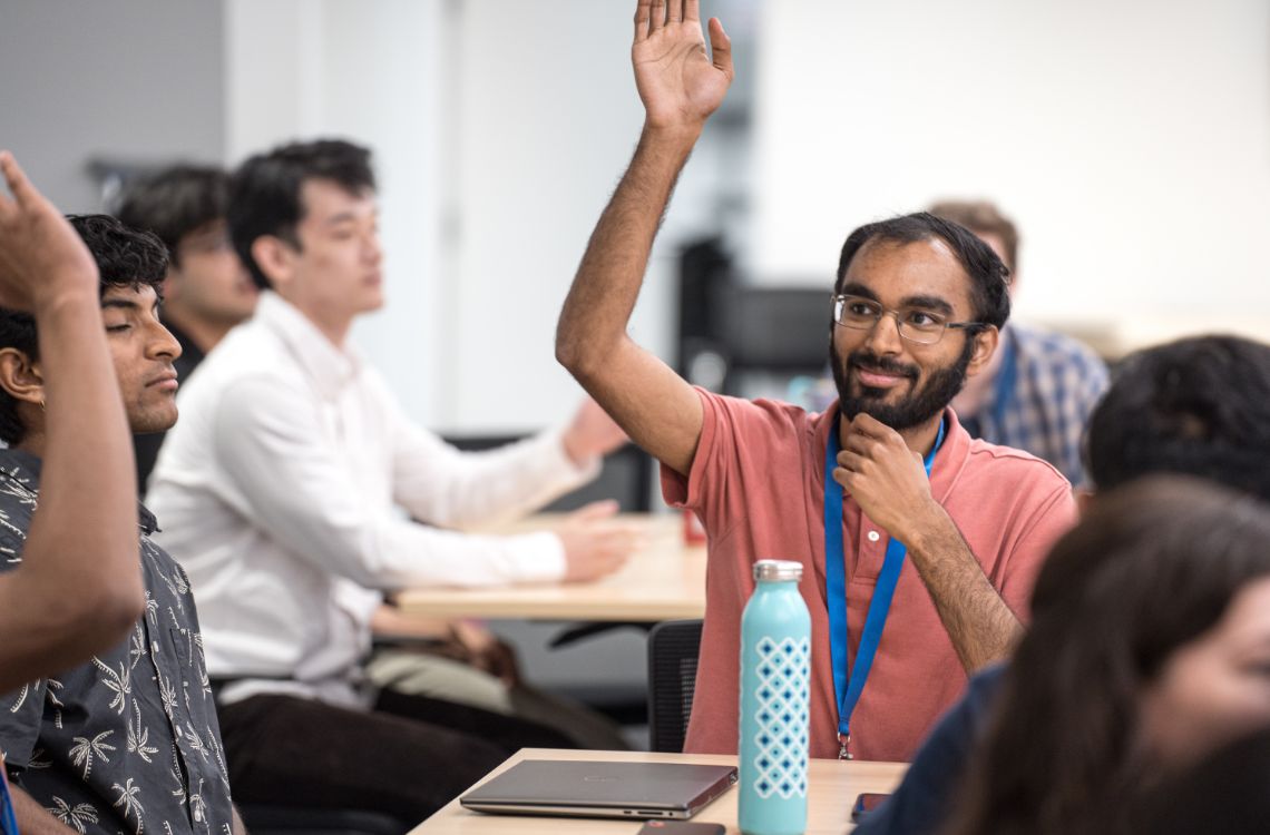 TST interns raising their hands with a question