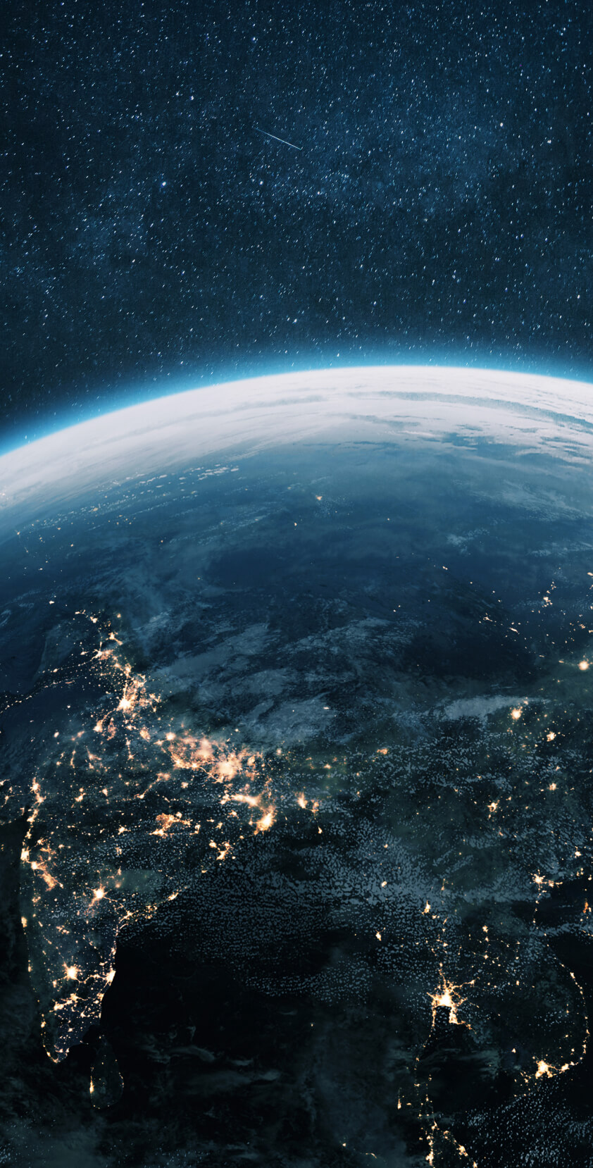 Night sky filled with stars and a shooting star above Earth’s illuminated surface, highlighting continents and city lights.