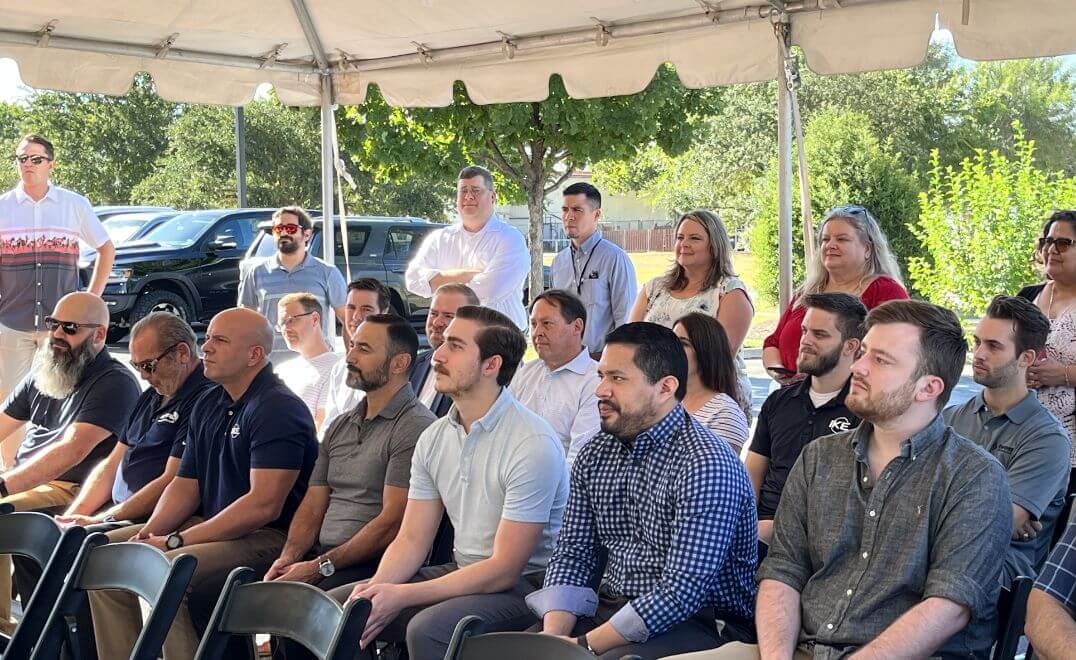 TST employees at an event meeting